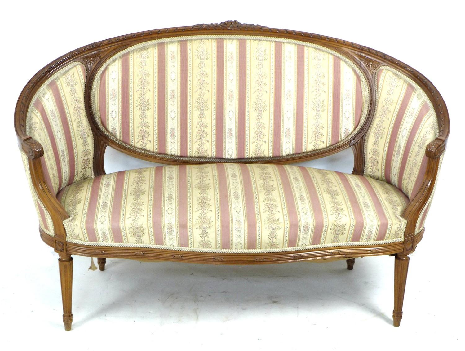 A French two seater settee, mid 20th century in Louis XVI style, with curved back with integral
