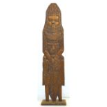 A mid 20th century tribal, Benin style carved wooden figure, wearing full armour and holding a