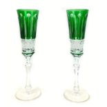 A pair of 20th century Faberge Xenia emerald green glass champagne flutes, both with Faberge marks