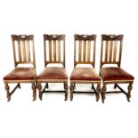A set of four late Victorian oak dining chairs, the rails carved with fruit and ribbons, slat backs,