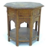 An Anglo-Indian folding table, late 19th / early 20th century, the octagonal lift-off top