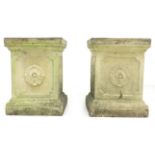 A pair of square form stoneware garden pedestals, each side decorated with a single rose, in