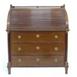 A 19th century Northern Continental roll top desk, pierced three quarter gallery over a drum fronted