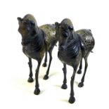 A pair of lacquered brass horses, likely 19th century Indian or Chinese, the etched back design