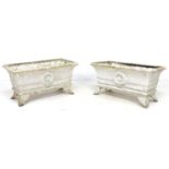 A pair of early 20th century cast iron rectangular planters, each with four outswept feet, with