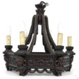 A mid 20th century carved oak chandelier, of hexagonal form with swept supporting arms, carved