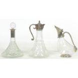 A group of three glass decanters, comprising a ship's decanter with silver plated 'Green Man' mask