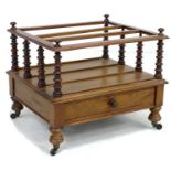 An early Victorian rosewood Canterbury, three division, single drawer with turned knob, raised