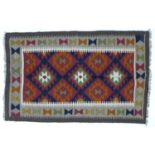 A Maimana Kilim rug with red ground, three white and olive green lozenges, white and grey dentil key