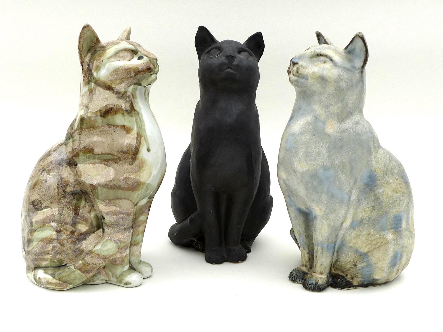 A group of three Northshore Ceramic cats, all the same casting but of differing colours and glaze