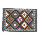 A Maimana Kilim rug, with diamond patterned field in white, orange, green, burgundy, and dark