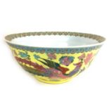 A large Chinese 20th century bowl, decorated with a floral rim to its interior and a phoenix and