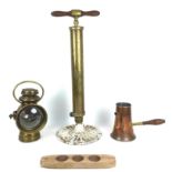 A group of copper and brass items and kitchenalia comprising a brass fireman's pump with cast iron