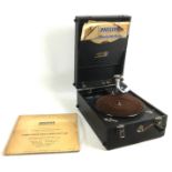 A vintage portable wind up gramophone player, with vinyl record. (2)