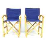 A pair of director style beech frame deck chairs, with blue canvas back rests and seats, 56 by 50 by