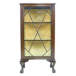 An Edwardian mahogany display cabinet, with astragal glazed single door, two shelves, raised upon