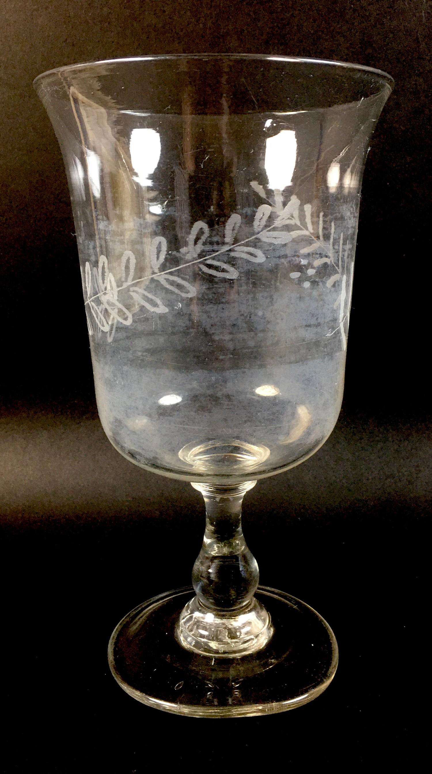 A Georgian glass celery vase, with a flared rim bell shaped bowl, with an etched foliate design, its