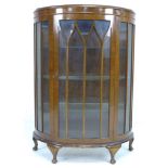 A 1950's mahogany veneered demi-lune display cabinet, single astragal glazed door, three glass