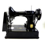A vintage Singer Featherweight 221K portable sewing machine, serial number EH244952, with fold out