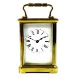 A French brass carriage clock, late 19th century, with five glass case, white dial with black