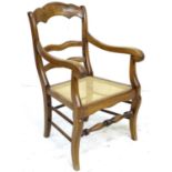 A Continental stained beech open armchair, early 20th century, with shaped three rail back and arms,