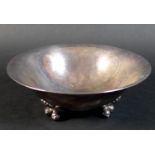 A Danish Sterling silver bowl of circular lobed form, raised on three feet, each shaped as a pair of