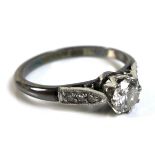 An 18ct white gold, platinum and diamond solitaire ring, of Art Deco design, the central diamond