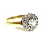 An 18ct gold diamond daisy cluster set ring, the central diamond 0.25ct, 4.4mm, surrounded by