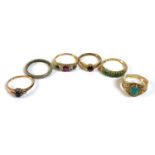 A group of six gold and unmarked metal rings, comprising a Victorian / Edwardian seven stone ring,