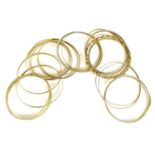 A group of twenty 9ct gold bangles, all marked, total weight 81.3g, together with four unmarked