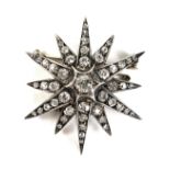 A late Victorian diamond set starburst brooch, the central diamond of approximately 0.25ct, 3.8mm,