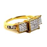 An 18ct gold and diamond multi-stone ring, with thirty four brilliant cut diamonds spread across