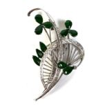 An 18ct white gold diamond and jade brooch, of foliate swirl design, the oval jade set as leaves,