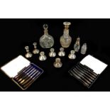 A collection of George V and later silver candlesticks and other wares, comprising a pair of ERII