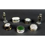 A group of silver and white metal pill boxes