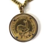 A 1952 George VI South Africa gold £1 coin, set in unmarked pendant mount with 9ct gold chain, total