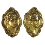 A pair of Art Nouveau unmarked yellow gold cufflinks, each of oval form, cast in relief with a young