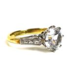 An 18ct gold solitaire ring, set with a large and impressive white stone, likely white sapphire,