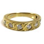 An 18ct gold and diamond half eternity ring, of modern rub-over design set with eight similarly