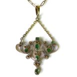 An emerald set pendant of delicate scrolling design, in Art Nouveau style, possibly Indian, yellow
