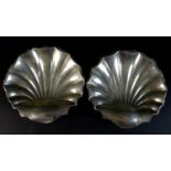 A pair of Edward VII silver shell form dishes, raised upon three ball feet, Atkin Brothers,