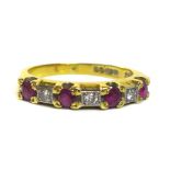 An 18ct gold, ruby and diamond seven stone ring, each of the four rubies of approximately 2.8mm,