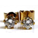 A pair of diamond ear studs, each of approximately 0.5ct, 5.06mm diameter, with 18ct gold