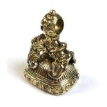 A Victorian gold plated fob seal, the rococo scroll mount set with an intaglio carved smoked quartz,