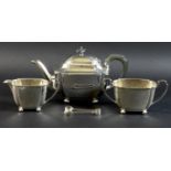 An Art Deco silver tea set, of curvilinear design with incuse corners, raised on four ball feet,