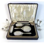 A group of George V silver dressing table items, comprising a cased part set silver and glass backed