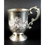 An Anglo Indian colonial silver christening tankard, with repousse Rococo style floral decoration
