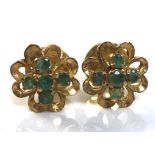 A pair of emerald cluster earrings, in yellow metal flower setting with quatrafoil of five small