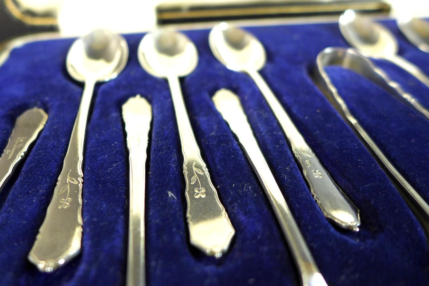 An Elizabeth II silver set of twelve teaspoons and pair of sugar nips, decorated with engraved - Image 4 of 6
