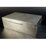 An Art Deco silver cigarette box, with engine turned decoration and Greek Key pattern to the
